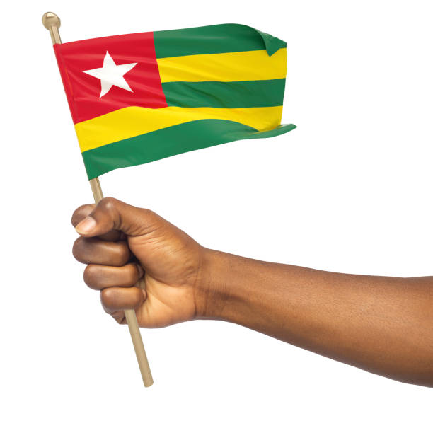 istock Hand holding Togolese national flag isolated on white background 1424439797