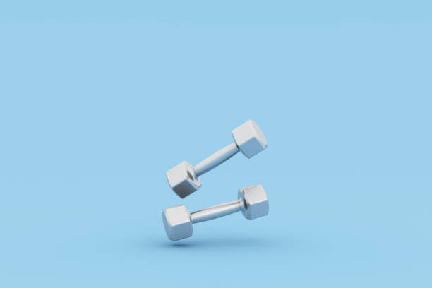 istock Two silver fitness dumbbells on blue background 1424447096