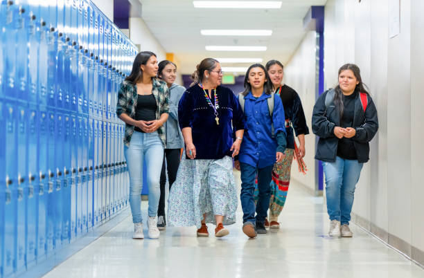 istock Best Friends and their teacher walking thru school corridor 1424467821