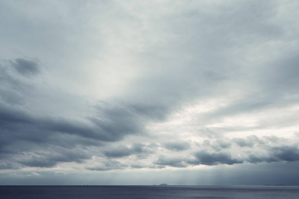 istock dark blue sea background, moody sky 1424469931