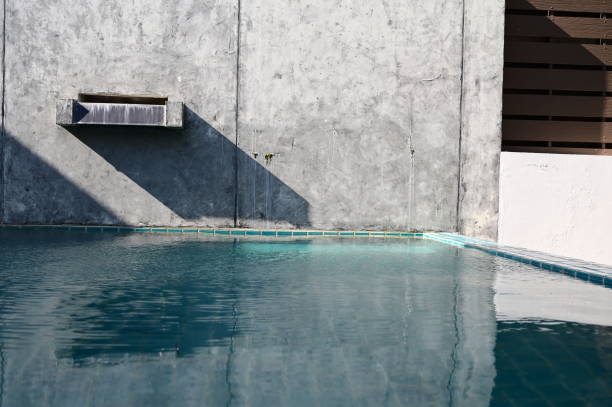 istock faucet of swimming pool on cement wall, construction industry 1424470037