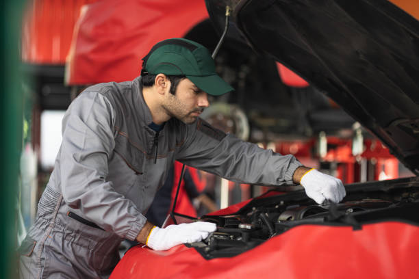 istock Automobile mechanic man checking car damage broken part condition. diagnostic and repairing vehicle at garage automotive, Concepts of car care check and fixed and services insurance. 1424477516