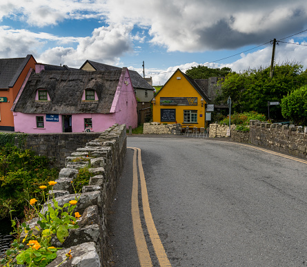 Doolin, Ireland - 3 August, 2022: bridge leads to colorful houses in the old village center of Doolin