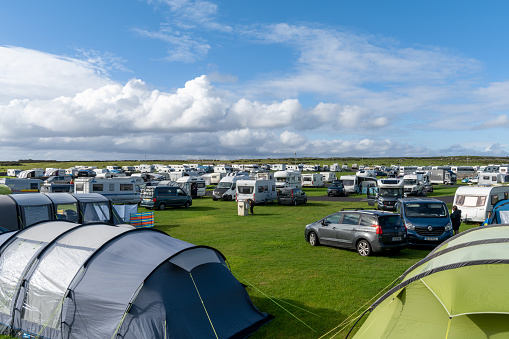 Doolin, Ireland - 3 August, 2022: view of a crowded and full campground in high summer with many tents and caravans