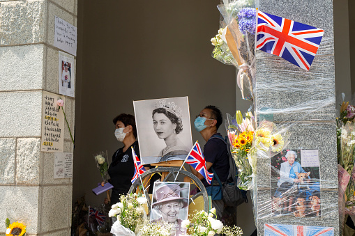 September 16, 2022,Hong Kong.People gather next to flowers placed as a tribute outside the British Consulate in Hong Kong on  following the death of Britain's Queen Elizabeth II.