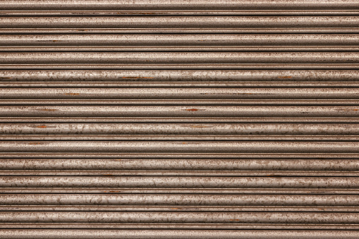 Metal garage door with repeating pattern.