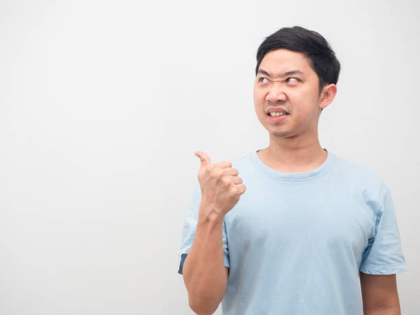 istock Man angry face looking and point finger at copy space white background 1424500413