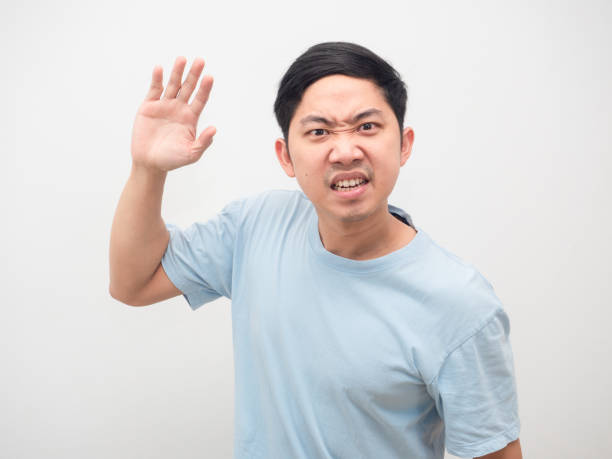 istock Man angry emotion show hand to hit portrait white background 1424500513
