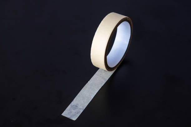 istock yellow paper tape isolated on black background 1424501054