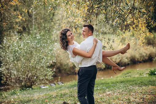 Beautiful happy couple married man and woman, portrait in nature