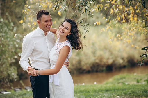 Beautiful happy couple married man and woman, portrait in nature