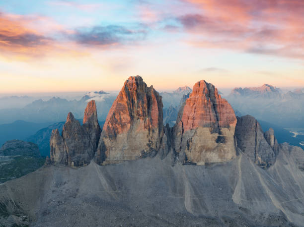 View from above, stunning aerial view of the Three Peaks of Lavaredo (Tre cime di Lavaredo) during a beautiful sunrise. The Three Peaks of Lavaredo are the undisputed symbol of the Dolomites, Italy. stock photo