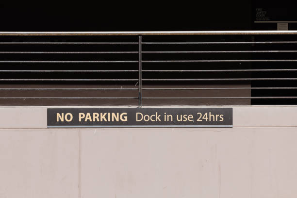 istock Old No parking sign on an old concrete wall 1424506264