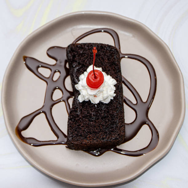 istock Brownie with cherry and creme 1424506880