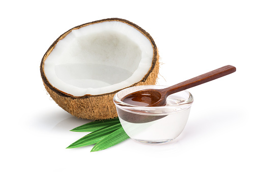 Coconut oil in glass bowl isolated on white background.