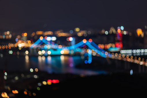The lights of the city cross-sea bridge at night are defocused