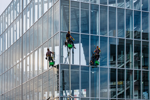 08.09.2022, Berlin, Germany, Rope access technician performing maintenance work on a building