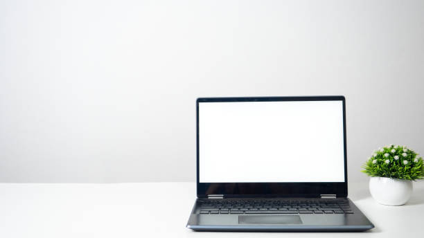 istock Laptop blank white screen on the table copy space 1424522216