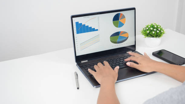 istock Hand using laptop charts graphs business at screen on the table copy space 1424522294