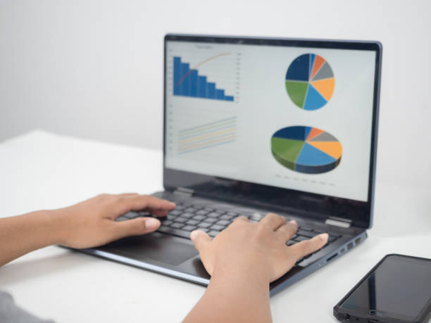 istock Close up hand using laptop charts graphs business at screen on the table 1424522299
