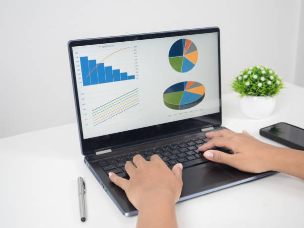 istock Close up hand using laptop charts graphs business at screen on the table copy space 1424522308