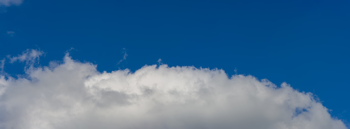 White cumulus cloud in the blue sky. Autumn. Web banner