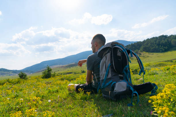 istock young man sits on looking at sun valley 1424548563