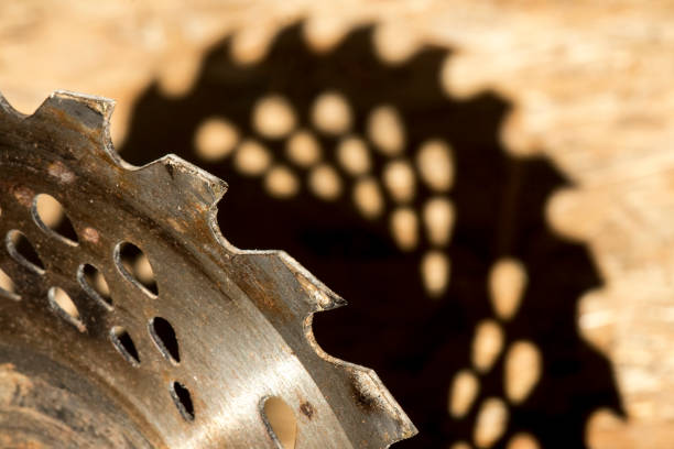 The old circular saw and shadow on a wooden background.