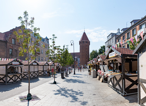 Gdansk, Poland - August 15, 2022: A picture of the Raiska Street during the St. Dominic's Fair, in Gdansk, with the Jacek Tower in the distance.