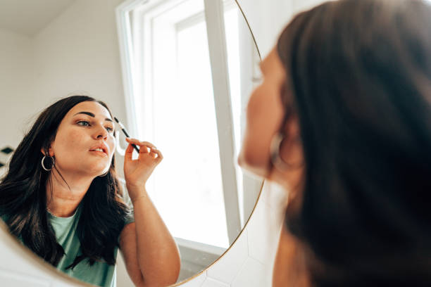 istock woman using make up in the bathroom 1424555530