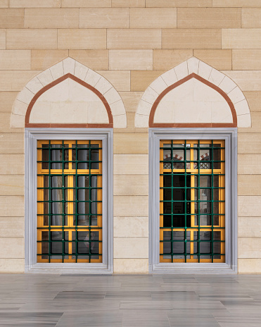 Two adjacent  wrought iron arched windows with modern architectural design at the courtyard of Camlica Mosque, Istanbul, Turkey