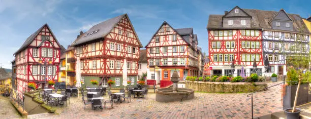 Ensemble of half-timbered houses, at the Kornmarkt in the historic old town of Wetzlar, Hesse with a deserted street cafe