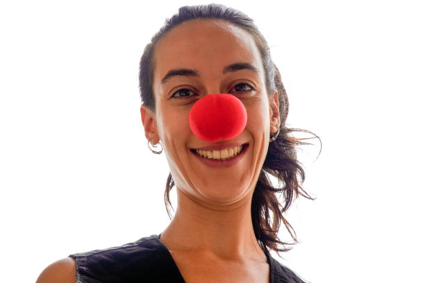 istock female clown looks at camera smiling 1424560597