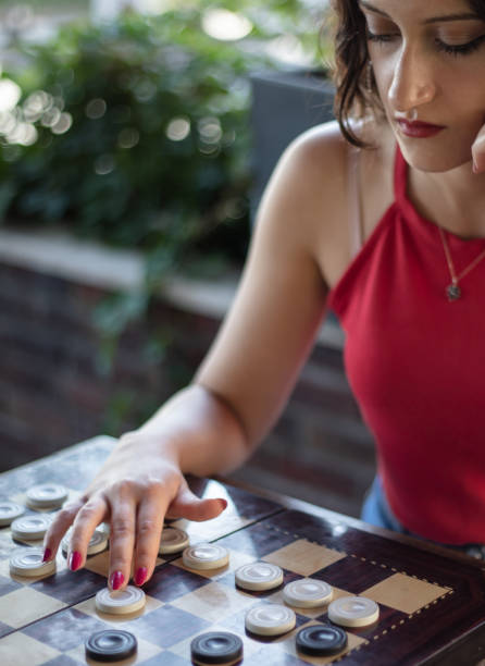 istock A girl playing checkers 1424561977