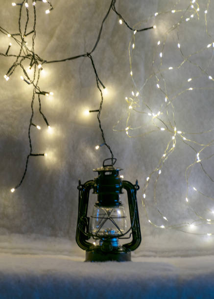 istock black lantern on white backlit background, colored lights background, christmas time 1424564237
