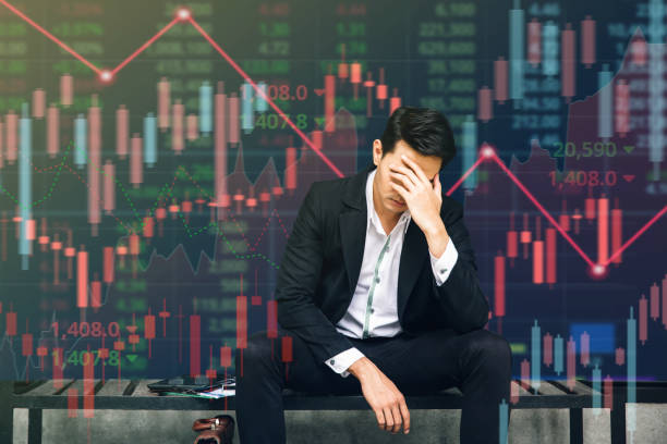 business failure and unemployment problems from the economic crisis. stressed businessman sits in panic digital stock market financial background. stock market and global economic inflation recession. - finance usa despair government imagens e fotografias de stock