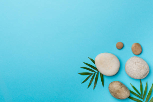 istock Spa stones and leaves on wooden background, top view 1424565002