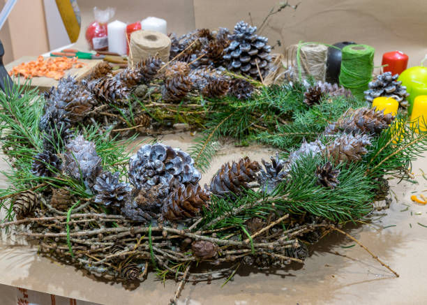 istock Christmas handmade diy background. Making craft xmas wreath and ornaments. Workplace for preparing handmade new year decorations. Winter holidays concept. Home leisure, tools, trinkets and details for holiday decorations 1424565298