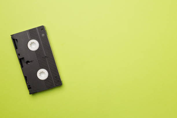 istock Old analog tape VHS cassette on color background, top view 1424575621