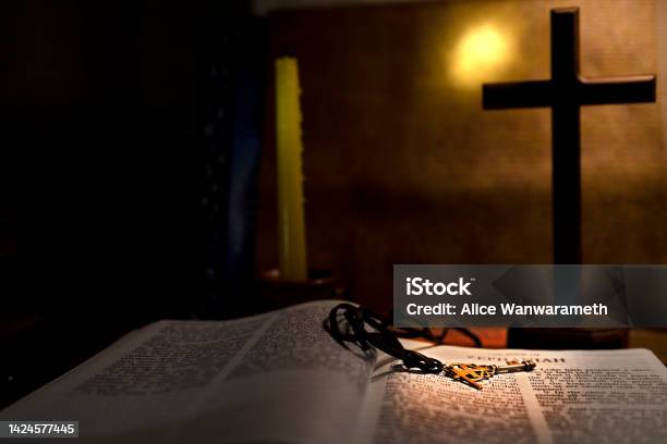Open Book Holy Bible Twith Wood Cross And Candle For Background And Inspiration Stock Photo - Download Image Now