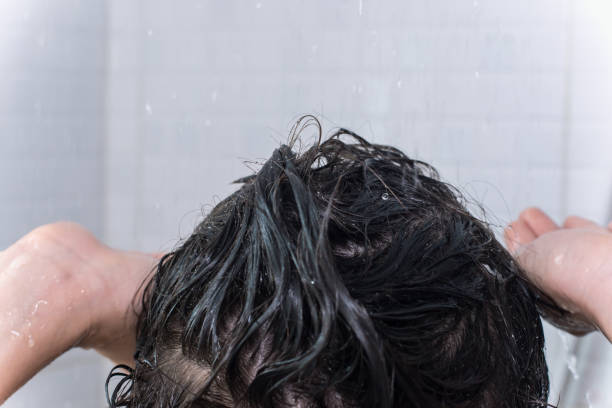 istock Fun and happy boy enjoying his bath while he stands under running water. 1424579694