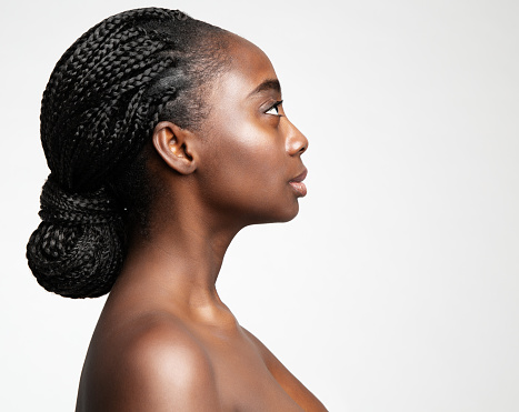 African Braids Hairstyle. Afro Hair Braided. Beauty Woman Face Profile. Dark Skin Care and Cosmetology. Fashion Model Side view Portrait isolated White Studio Background