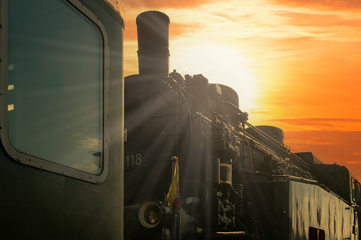 old steam locomotive at sunset