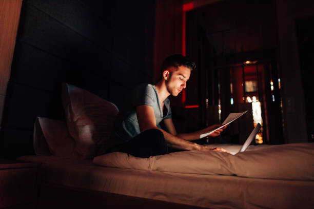 istock man working in the bed at late night 1424583223