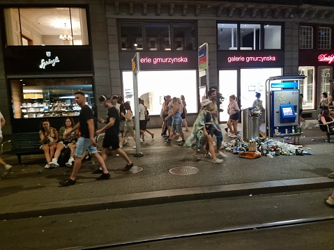 Zurich City during the Street Parade 2012. People dancing to one of the largest electronic music festivals in the world. The first time the Street Parade was organized in 1992. In the last years participated arround 1 million people. The image shows people after the event has finishes.