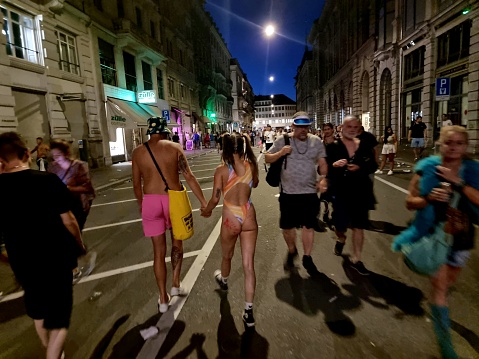 Zurich City during the Street Parade 2012. People dancing to one of the largest electronic music festivals in the world. The first time the Street Parade was organized in 1992. In the last years participated arround 1 million people. The image shows people after the event has finishes.