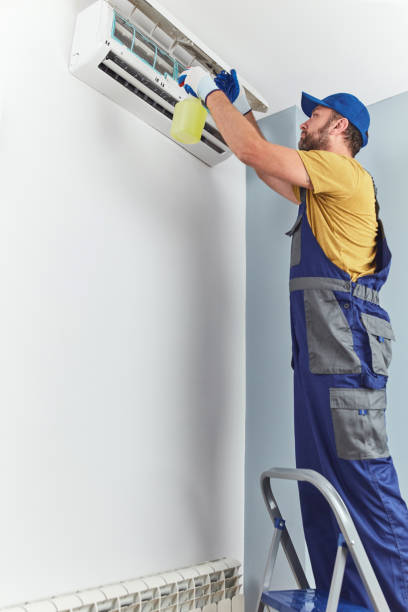 istock Repairman cleaning and fixing indoors AC unit. 1424587332