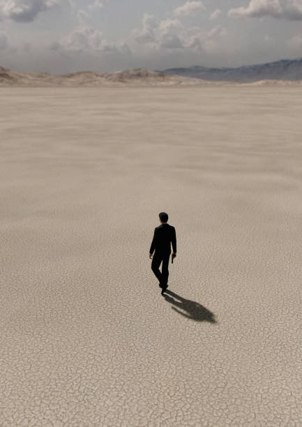 istock Man in black suit with gun walks in desert. High angle view. 3D render. 1424592591