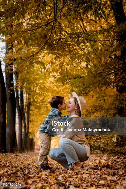 Mother And Her Little Son Are Touching Their Noses And Smiling The Family Is Dressed In Autumn Clothes Happy Together Stock Photo - Download Image Now
