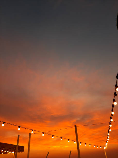 istock Bulb garland against the summer sky in sunset 1424598924